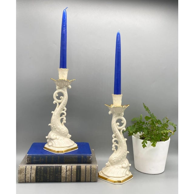 Stunning pair of creamware dolphin candlesticks by Lenox. Asian inspired pieces from the late 20th century with hand...