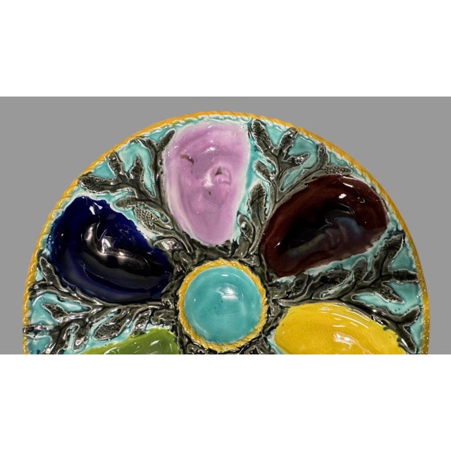 S. Fielding & Co. English Majolica Multicolored Oyster Plate depicts multi-colored wells on turquoise background with...
