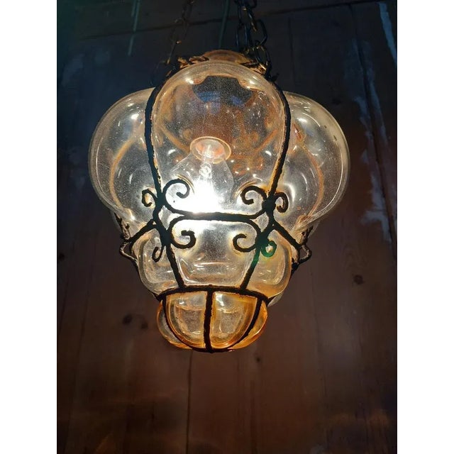 Fused blown glass lantern lamp on iron lattice base from Campo San Polo in Venice. The antiquity and originality of the...