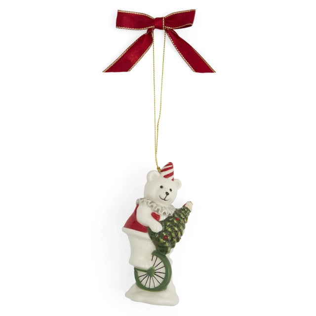 Balancing on a unicycle and carrying the iconic Spode christmas tree, this whimsical bear ornament is adorned with a...