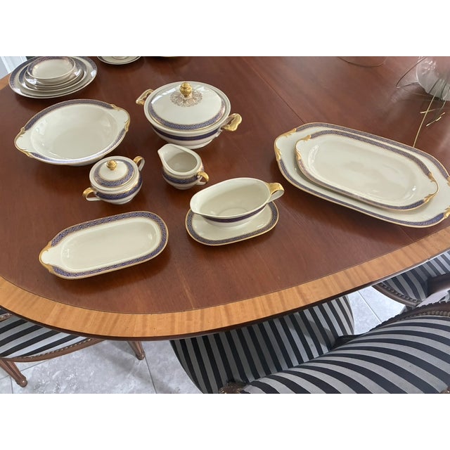 This dinnerware set has been in my family for over 70+ years. Each piece features a white body, decorated with dark blue...