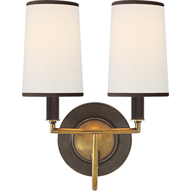 Description: The Elkins by Thomas O'Brien features a rich mix of materials. With sleek arms, elongated shades, and...