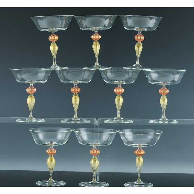 Vintage Murano Glass Champagne Coupes, Peach and Gold-Leaf Ribbed Stems, Set of Ten Mid-to-Late 20th Century This set of...