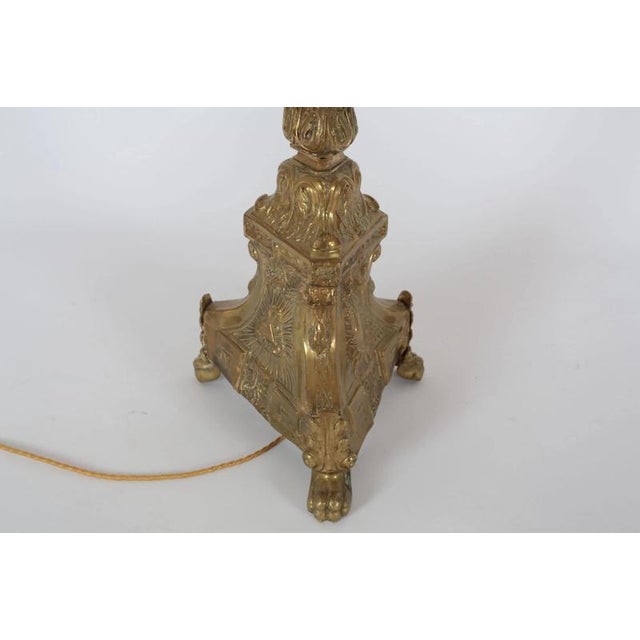 Brass floor lamp - originally it was a candlestick. There are religious motifs on the candlestick. The lamp is very nicely...