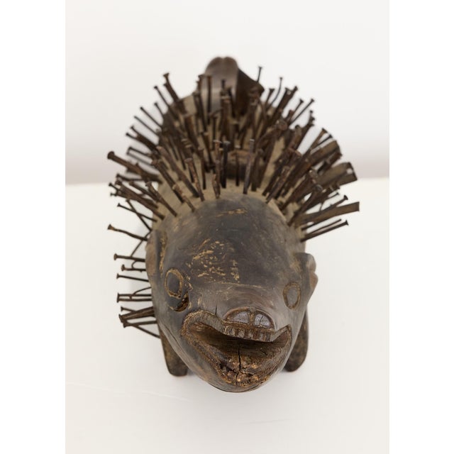 A powerful and ethnographically significant example of Central African ritual sculpture, this nail-studded zoomorphic...