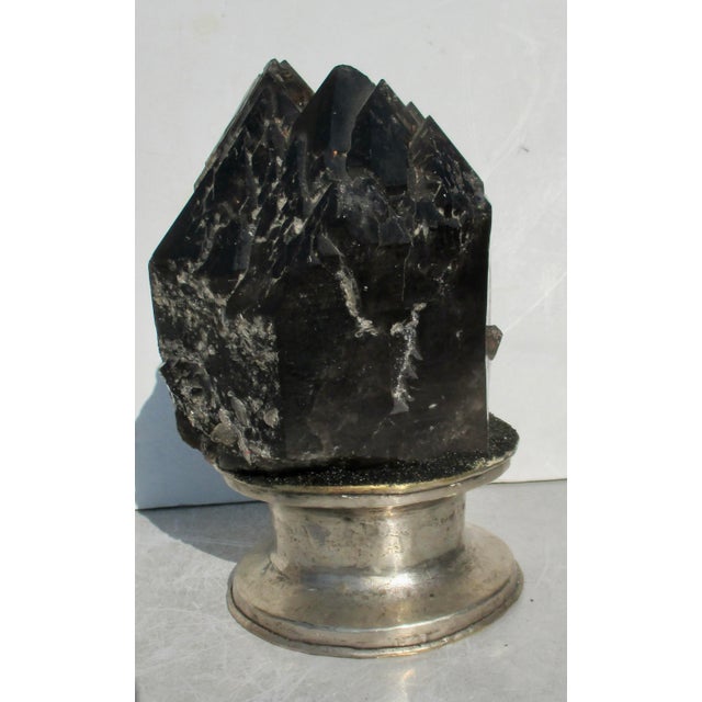 Black Quartz crystal point set into a plaster and aluminum mounting. Great point in natural form. Set into an upright...