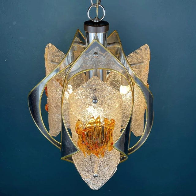 Mid-Century amber Murano chandelier Mazzega by Toni Zuccheri was made in Italy in the 1970s. Although the lamp is not...