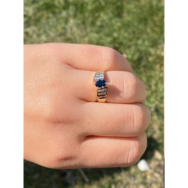 The Geraldine: Ladies 14K Gold Sapphire and Diamond Ring. Crafted in 14 karat yellow gold, this ring centers on a 0.60...