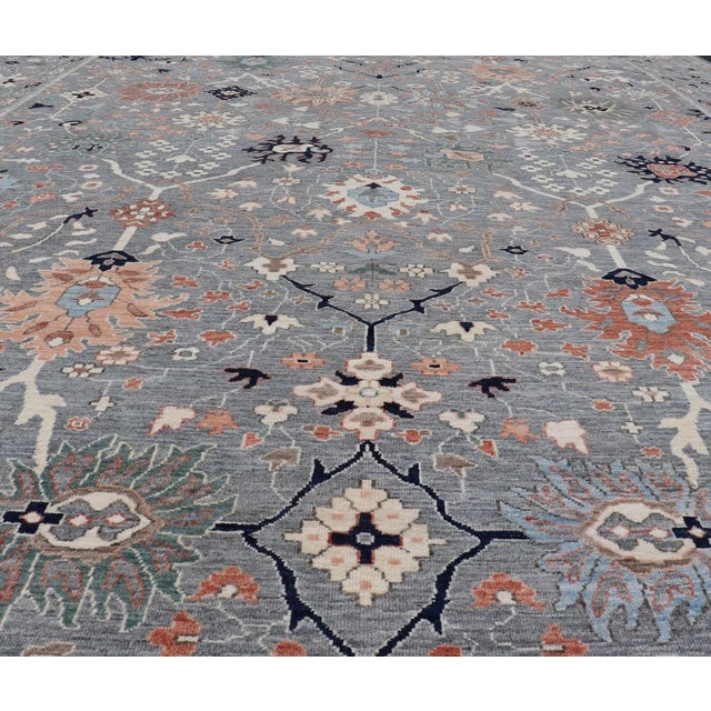 Oushaks are known for their floral-inspired motifs, this piece has a more modern feel with bright corals, pinks, greens...