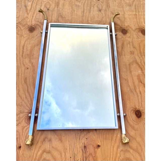 Exceptional and highly decorative statement mirror featuring dramatic falcon head and claw foot motifs rendered in finely...