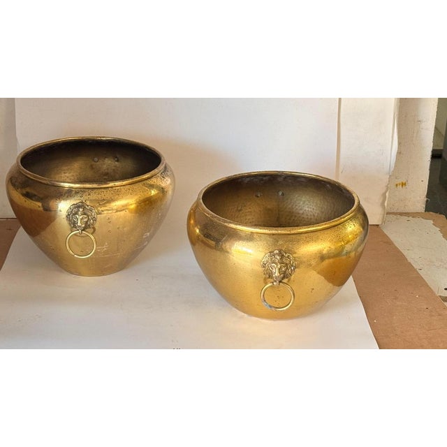Pair of 1950s French Brass Cache-Pots – Lion Head Ornaments & Ring Handles : This elegant pair of French brass cache-pots...