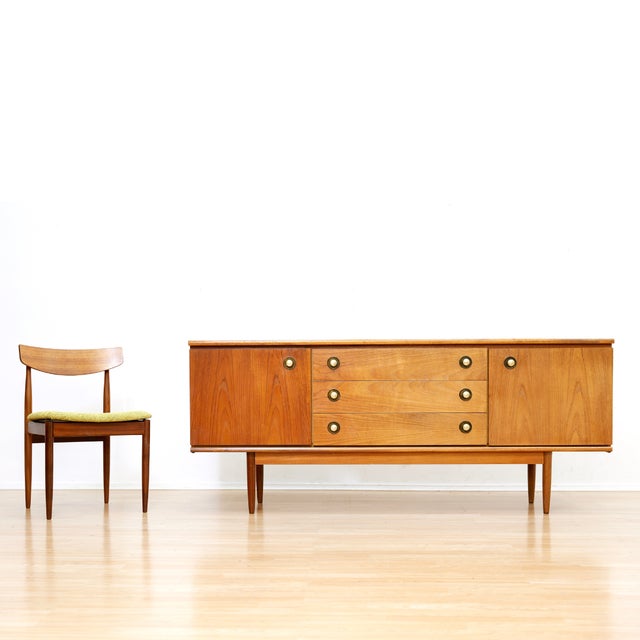 This mid-century credenza was produced by in England during the 1960s. Made from teak with a Scandinavian influence, it is...