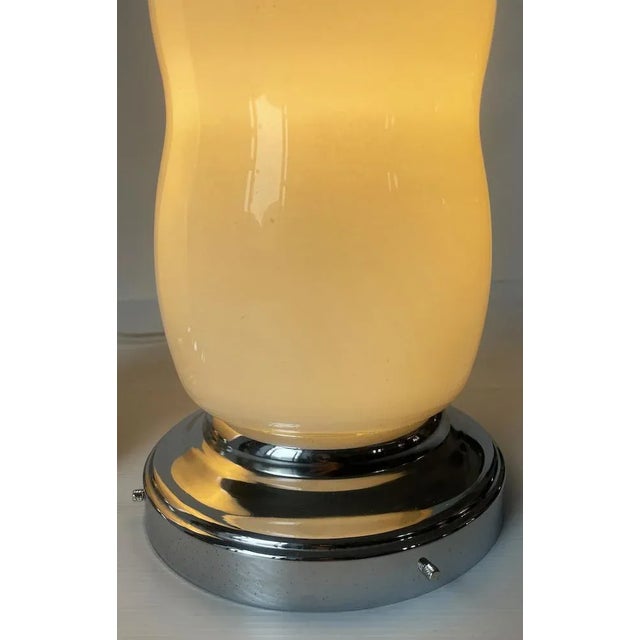 Elegant pair of vintage table lamps with white lacquered glass lampshade and steel base. Origin: Italy Period: 70s...