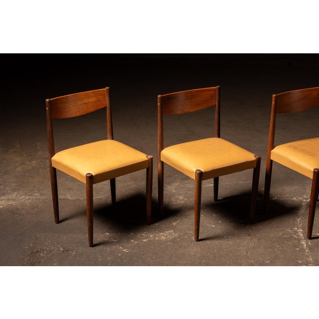 Set of four Danish Modern dining chairs designed by Poul Volther and produced by Frem Røjle. The chairs feature solid teak...