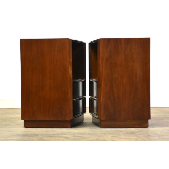 A pair of mid century modern modern walnut single drawer spear tip nightstands designed by T.H. Robsjohn Gibbings for...