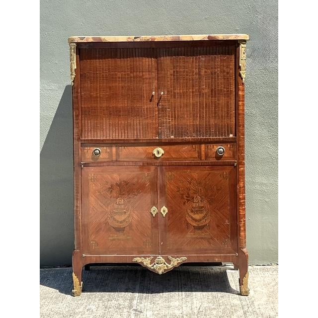 This exquisite Louis XVI style French secretaire is a masterwork of neoclassical design, blending high-utility storage...