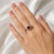 Exquisite 18K white gold and platinum antique ring featuring a 1.5 carat natural round garnet surrounded by numerous...