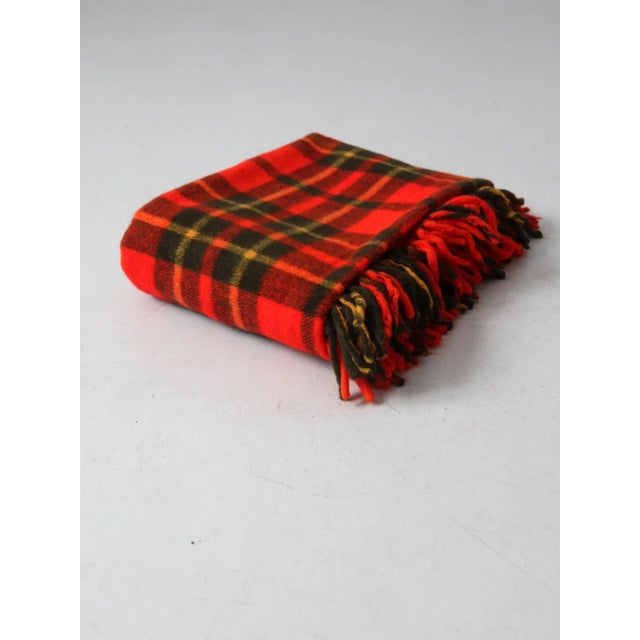 This is a Faribo plaid woolen blanket circa 1960. The classic throw blanket features a red, black, and gold plaid with...