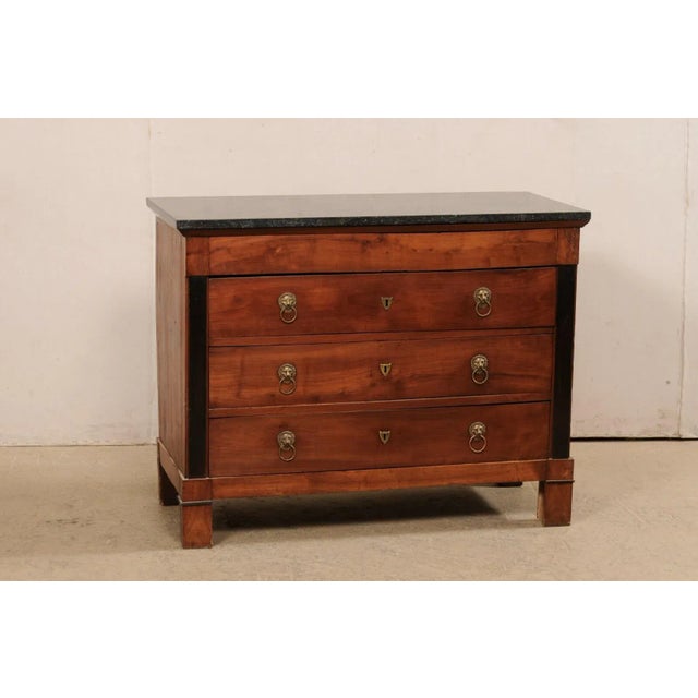 A French Neoclassical commode with four drawers and marble top from the 19th century. This antique chest from France...