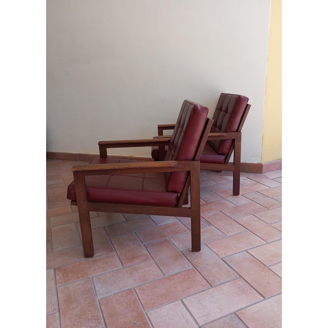 Pair of teak armchairs designed by Danish designer Illum Wilkelsø (1919-1999) and made by Niels Eilersen in the 1960s This...