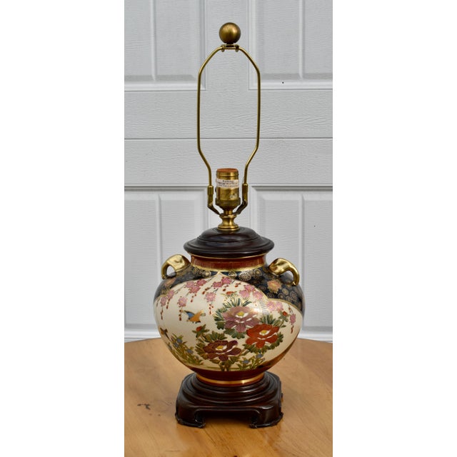 Vintage (1970's) Table Lamp has an Asian Style. Made of Ceramic with Wood at the Top and Bottom Base in a Muti-Colored...