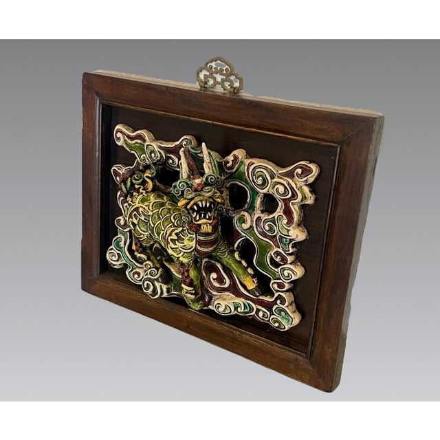 Magnificent Chinese Shiwan tile of a Qilin (麒麟) mounted within an expensive two tone custom wood frame completed with a...