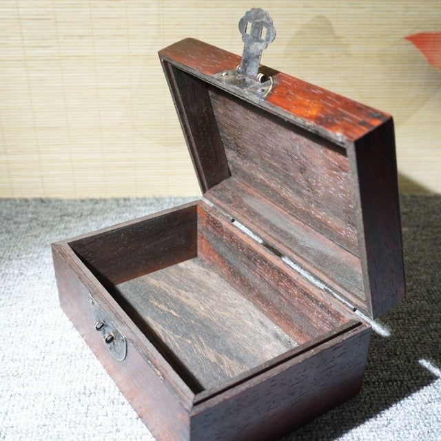 This handsome wooden storage box is hand‑inlaid with colourful mother‑of‑pearl shell. The lid features traditional Chinese...