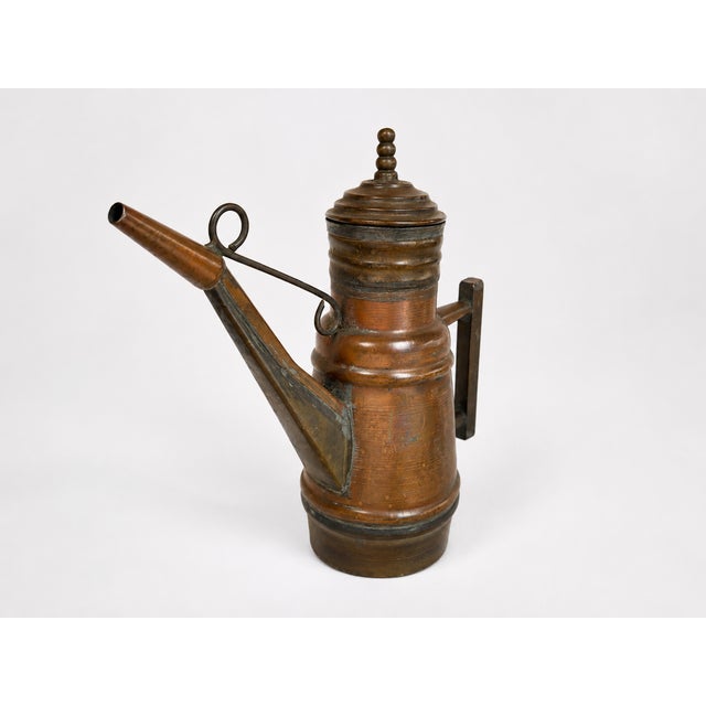 Vintage copper and brass oil can with a long tapered spout, tiered lid, side handle, and beautifully aged copper-brown...