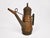 Vintage copper and brass oil can with a long tapered spout, tiered lid, side handle, and beautifully aged copper-brown...
