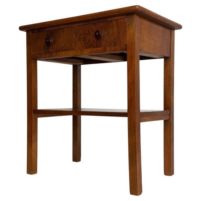 A charming early 20th-century English Edwardian side table, finely crafted from teak and combining practical storage with...