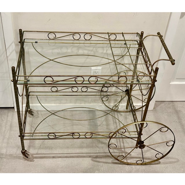 This ornate Hollywood Regency brass bar cart is a showstopper — a glamorous mid‑century treasure that instantly elevates...