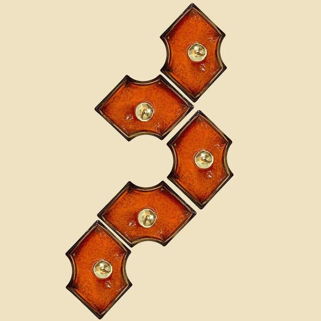 Orange and brown ceramic wall lights in fat lava style. Manufactured in germany in the 1970s. The style of the glaze is...
