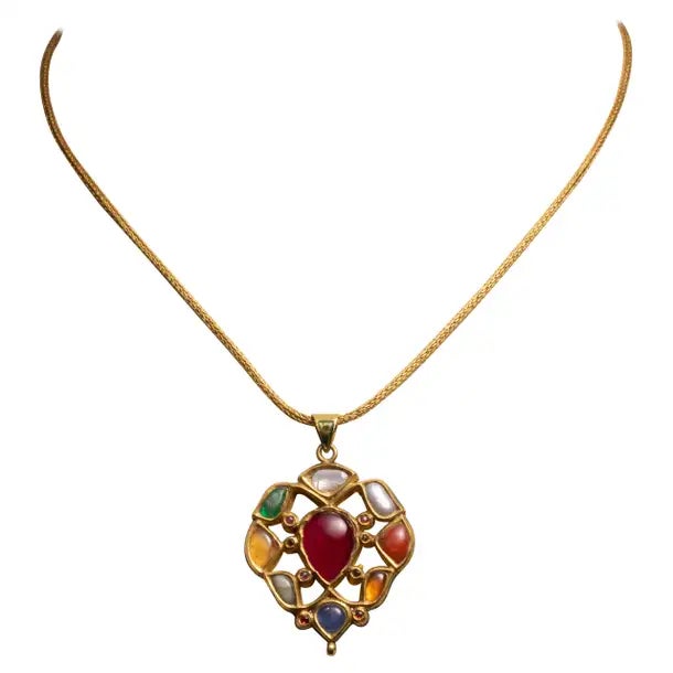 A 22K gold pendant with precious and semi-precious gemstones depicting the Navratna mythology on one side and kundan gold...