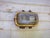 Vintage industrial bulkhead wall light made in Romania, featuring a substantial brass-toned metal body and thick ribbed...