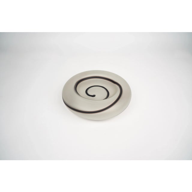 Vide poche in glass decored with a black aspiral attributed to the Italian designer Tommaso Barbi. Made in Italy in the...