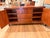 We are selling our Mitchell Gold + Bob Williams sideboard / credenza. It's a warm walnut-toned wood finish with red...