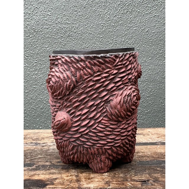 This vintage sculptural ceramic vase brings a richly textured, organic presence to a collected interior. Its deeply carved...
