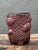 This vintage sculptural ceramic vase brings a richly textured, organic presence to a collected interior. Its deeply carved...