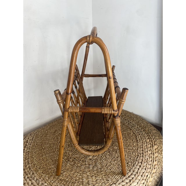 Large vintage magazine rack in rattan and bamboo, an iconic storage accessory from the 1960s/70s. It features a...