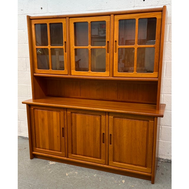 Beautiful mid-century Danish teak china hutch and credenza, showcasing the warm, rich tones and clean architectural lines...