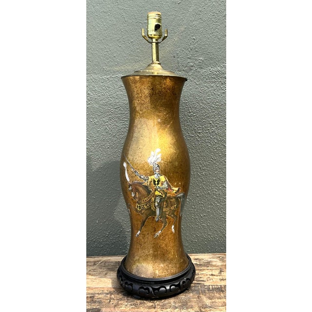 This striking vintage Italian table lamp showcases the elegant verre églomisé technique, featuring a reverse-gilded glass...