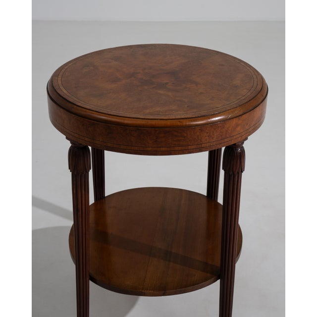 A circa 1920 French side table in the bouillotte style, designed with a compact circular top and slender supporting legs....