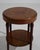 A circa 1920 French side table in the bouillotte style, designed with a compact circular top and slender supporting legs....