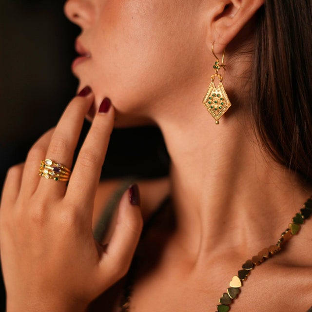 Step into timeless elegance with the Vintage Style Gold & Emerald Design Dangle Earrings . These exquisite earrings are...