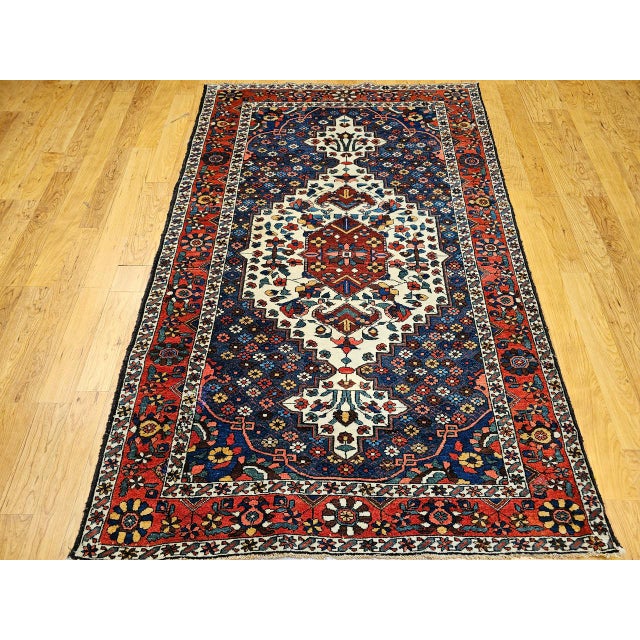 "Early 20th Century Vintage Persian Bakhtiari Bibibaft Area Rug beautifully hand knotted by the skilled weavers of...