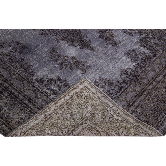 Beautiful Vintage Overdyed hand-knotted wool rug with a gray field. This Persian rug has black accents in an all-over...