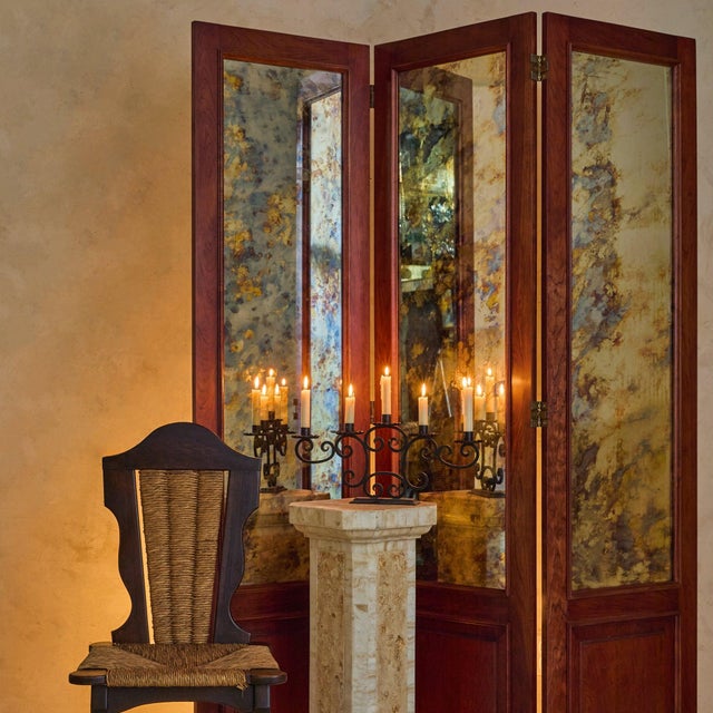 Sourced in Paris, a 20th century French three-panel folding screen with richly mottled antiqued mirror glass panels. Set...