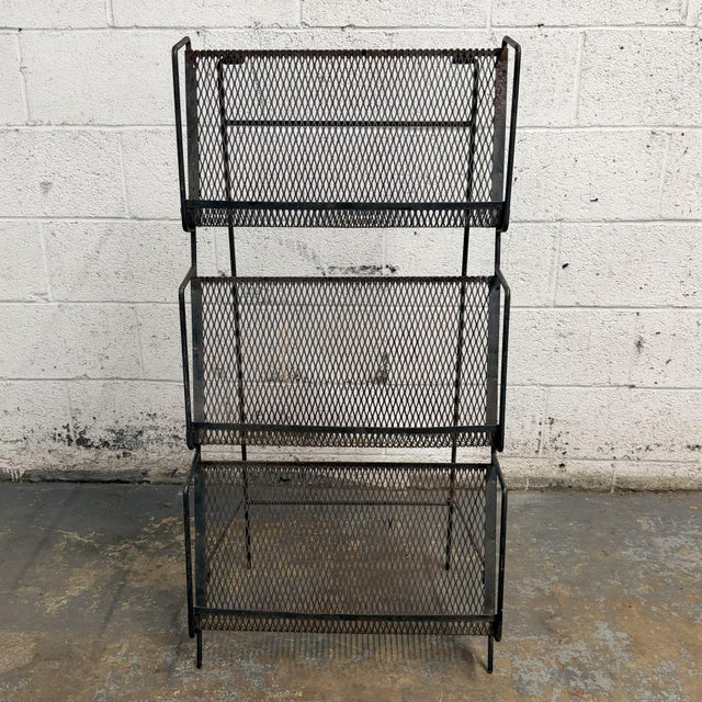 This mid-century iron magazine stand has a great utilitarian look, with open expanded metal mesh panels, slim tubular side...