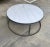 A Carrara marble-top coffee table with an Iron finished round base. The top is new and the base is vintage. We had to...