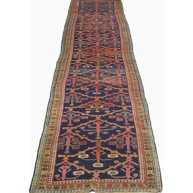 ACTUAL SIZE: 3’6″ x 17’10” PRIMARY COLOR: Navy / Beige AGE: Antique MATERIALS: Wool FOUNDATION: Cotton PRODUCTION:...